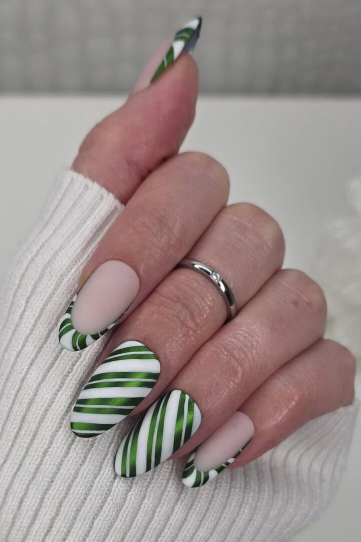 Long almond nails with green and white diagonal candy cane stripes