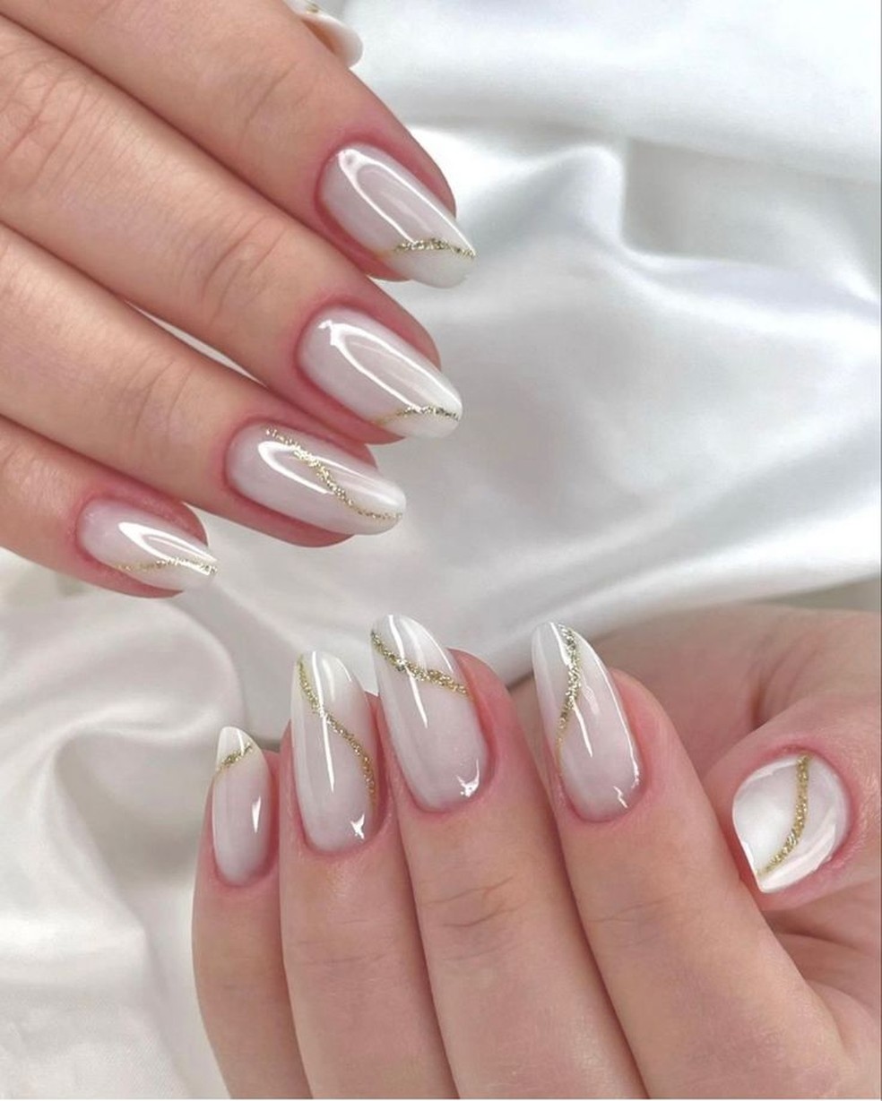 Milky white almond nails with thin gold line art