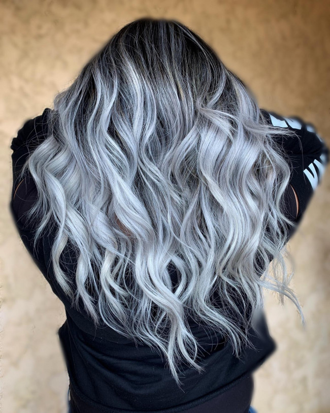 Back view of long tousled waves with a black base melting into pewter-silver ends