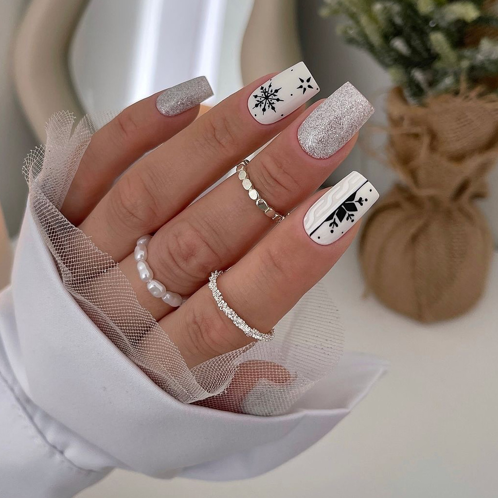 Silver glitter Christmas nails with white and black snowflake line art