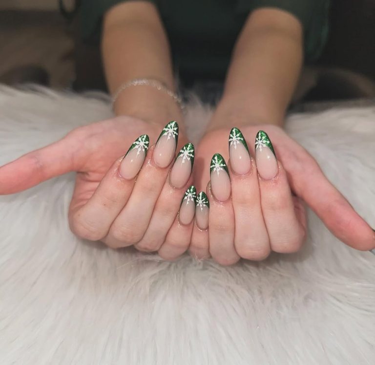 Emerald green french tip nails with white snowflake nail art