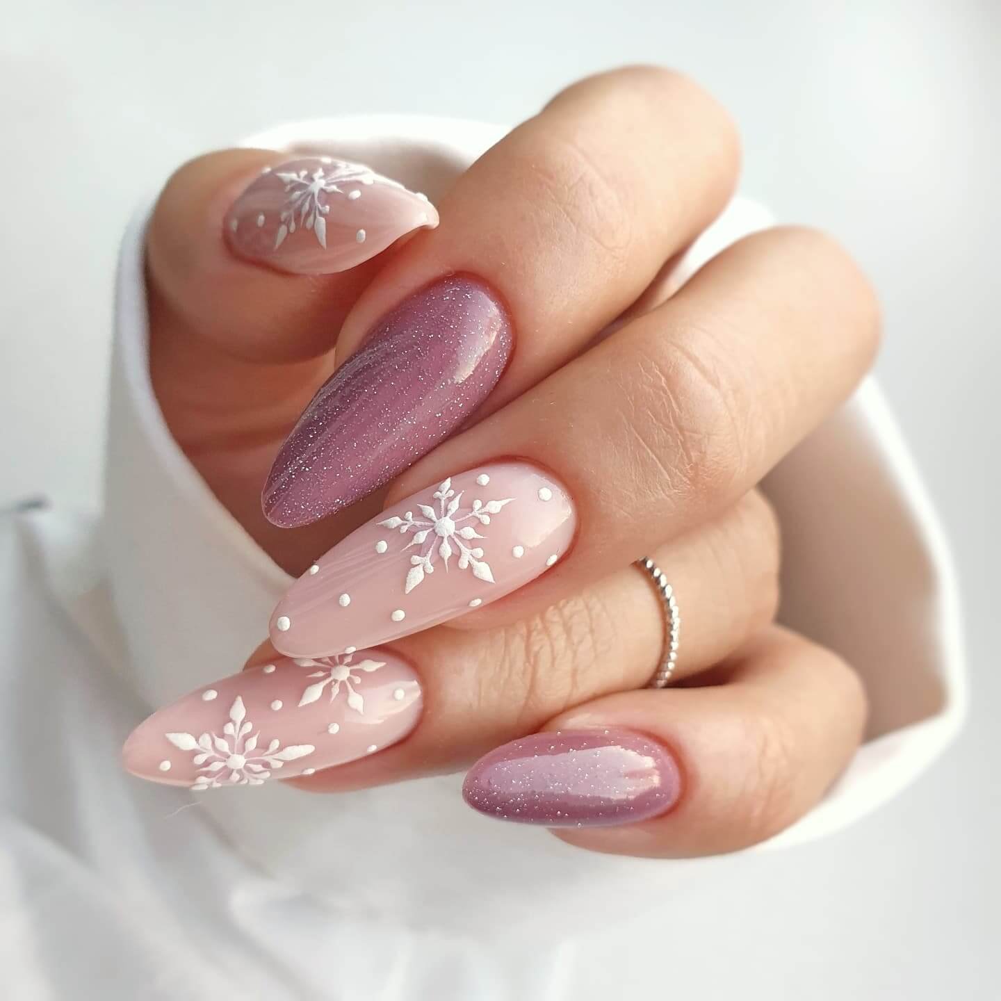 Soft pink nails with white snow dot nail art
