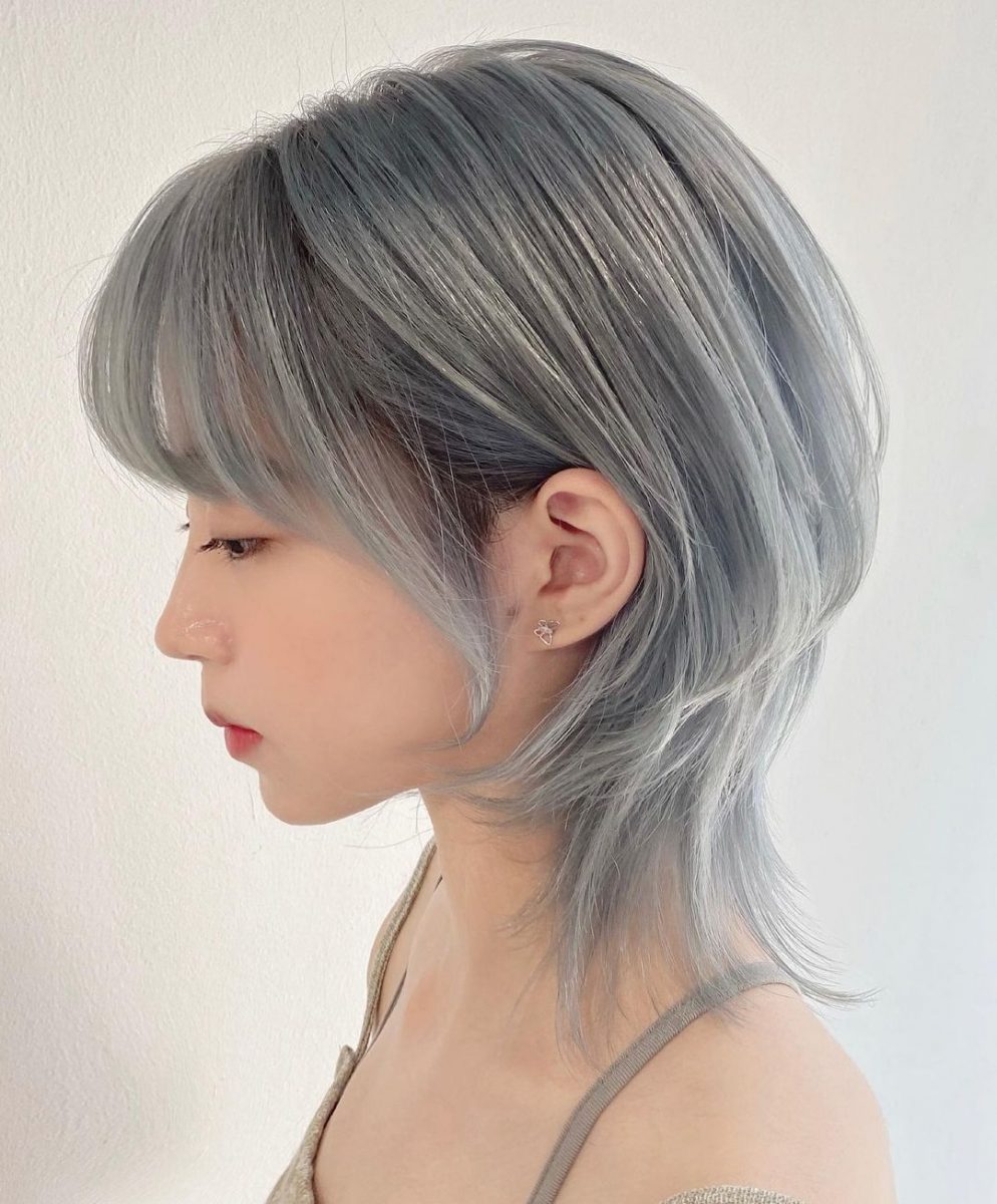 Silver-grey short wolf cut with wispy bangs, side profile