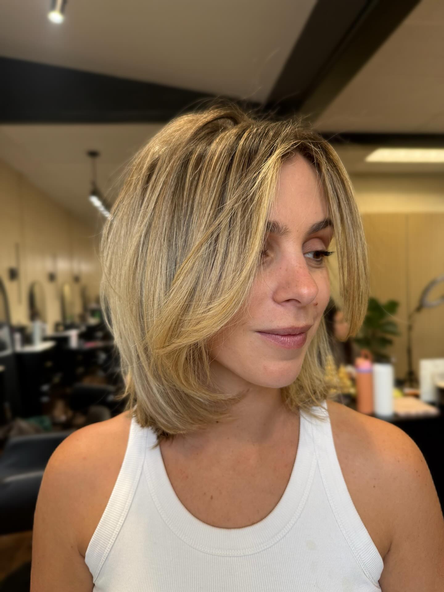 Golden shoulder-grazing Italian bob with face-framing layers and soft waves