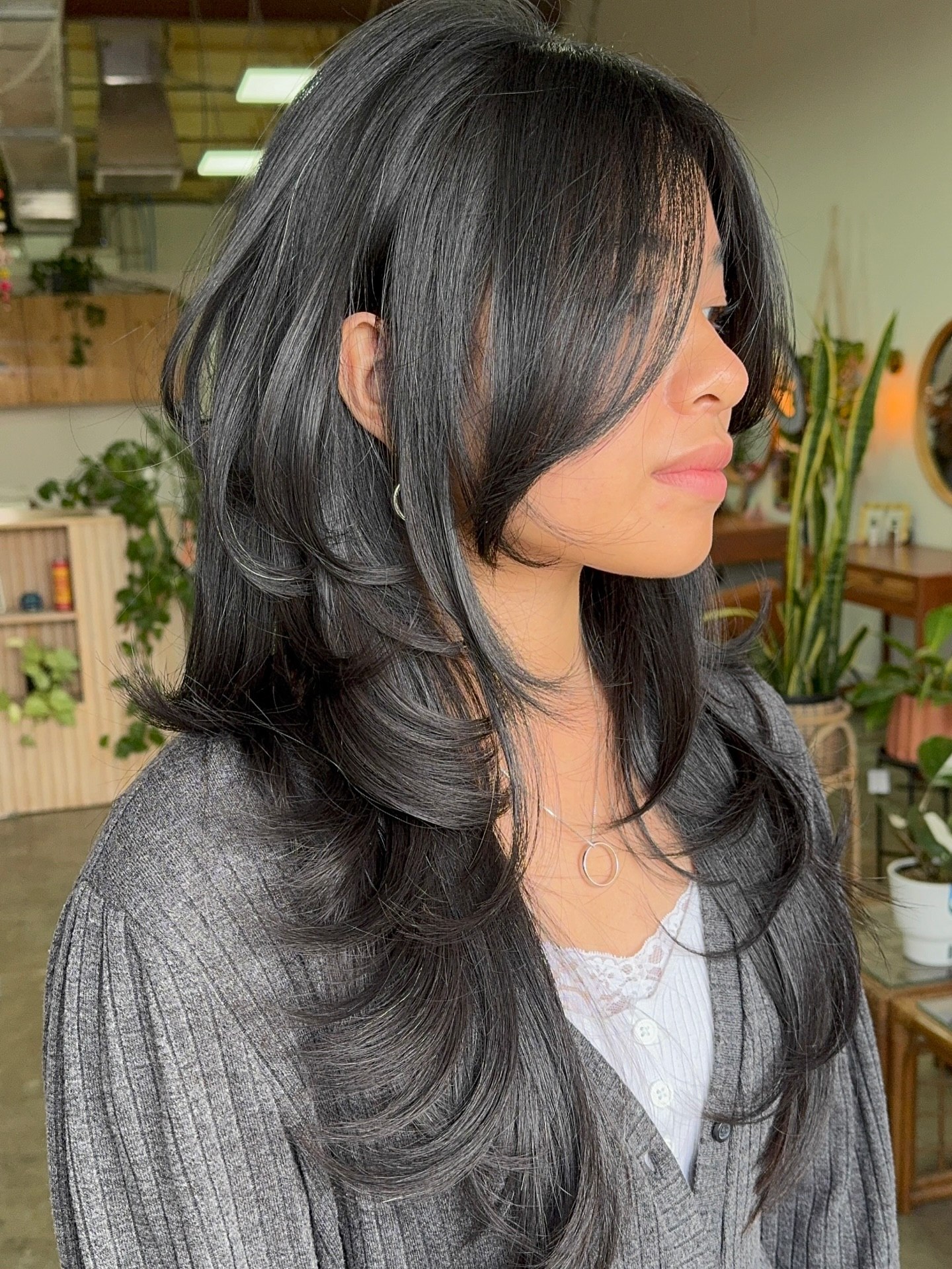 Long hair with wispy curtain bangs and soft face-framing layers