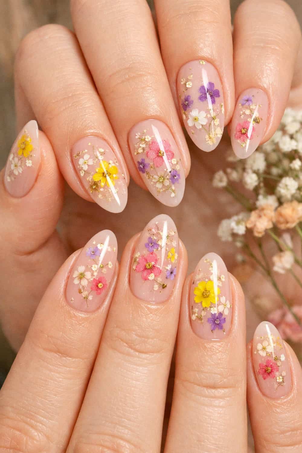 Sheer pink nails with dried flower nail art