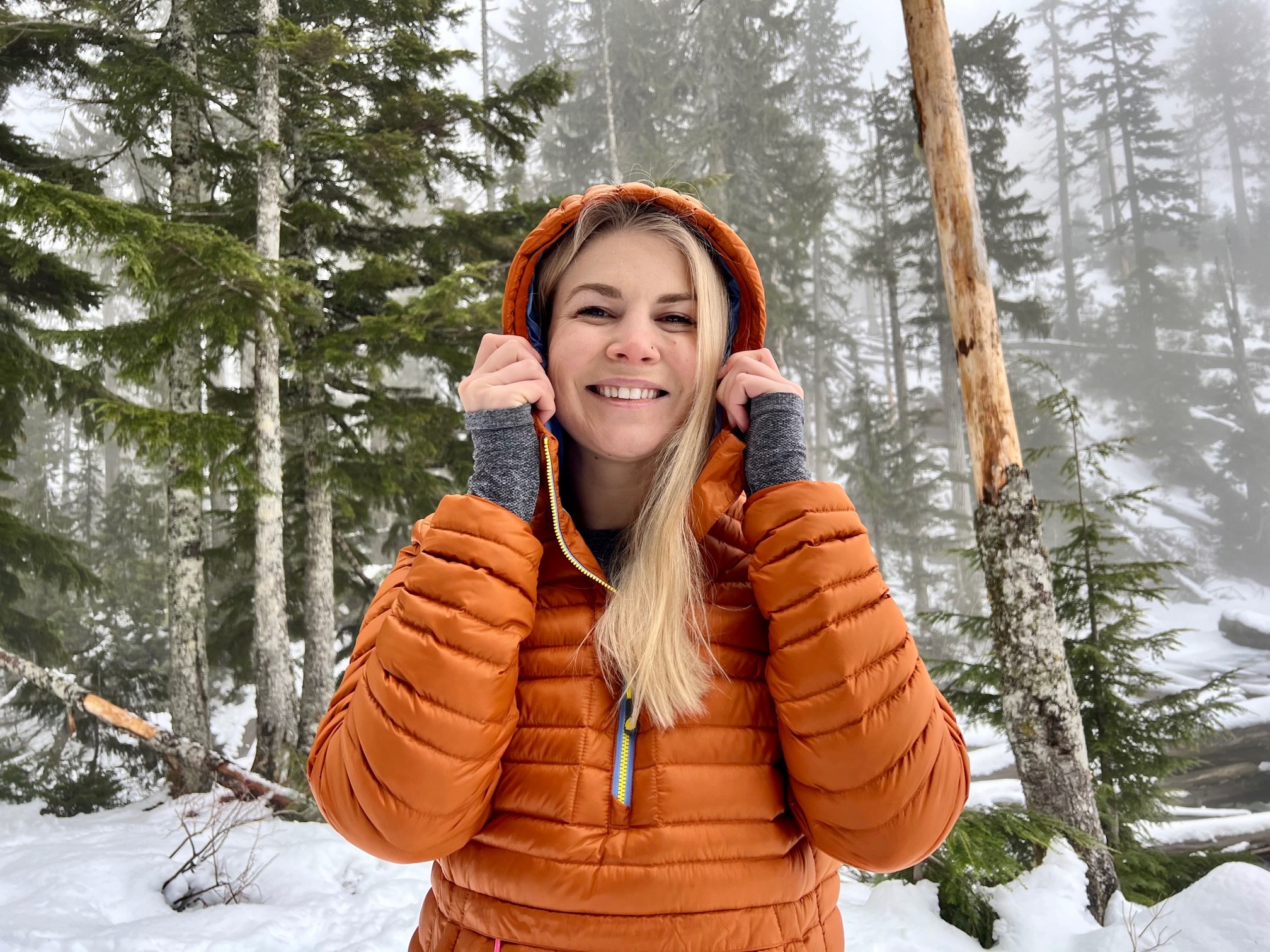 Woman wearing a technical softshell jacket on an active winter hike