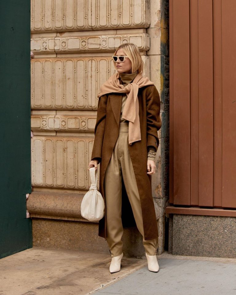 Woman wearing a camel wrap coat with wide-leg trousers