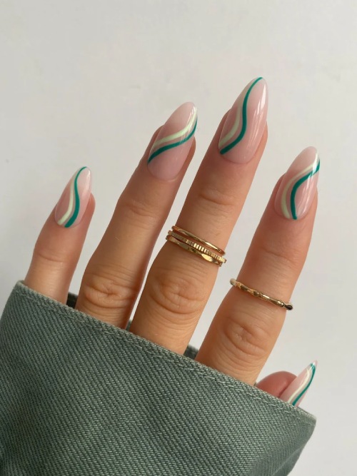 Short almond sage-green nails with cream swirl art