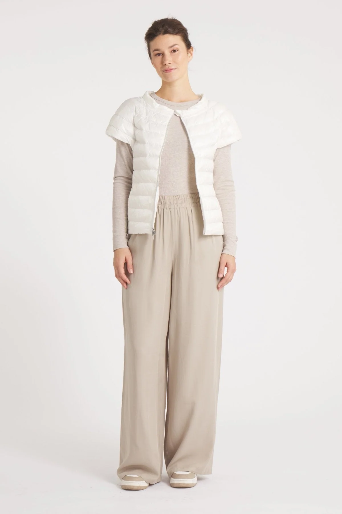 Ivory quilted down vest for layering over winter whites