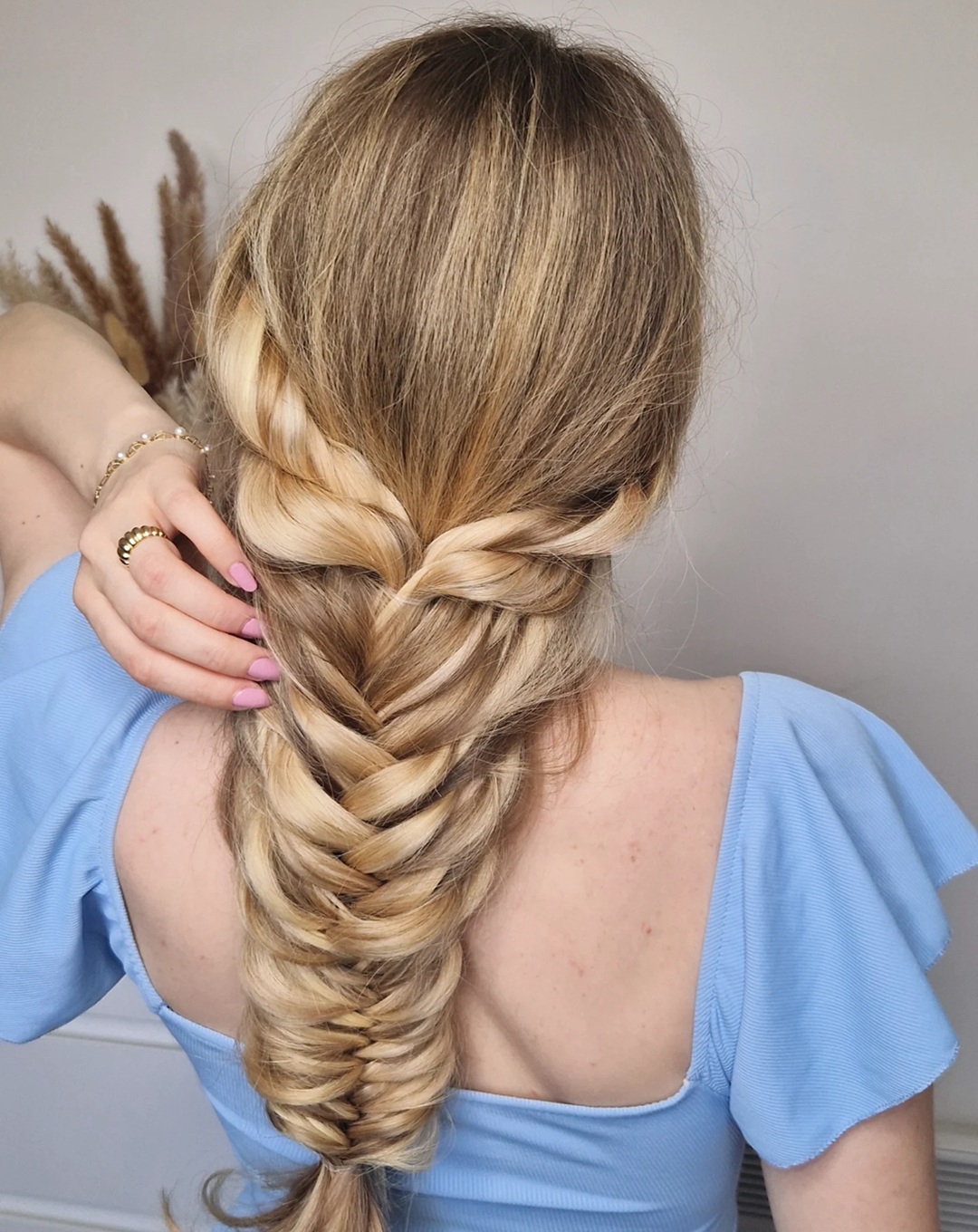 Thick fishtail braid on blonde hair