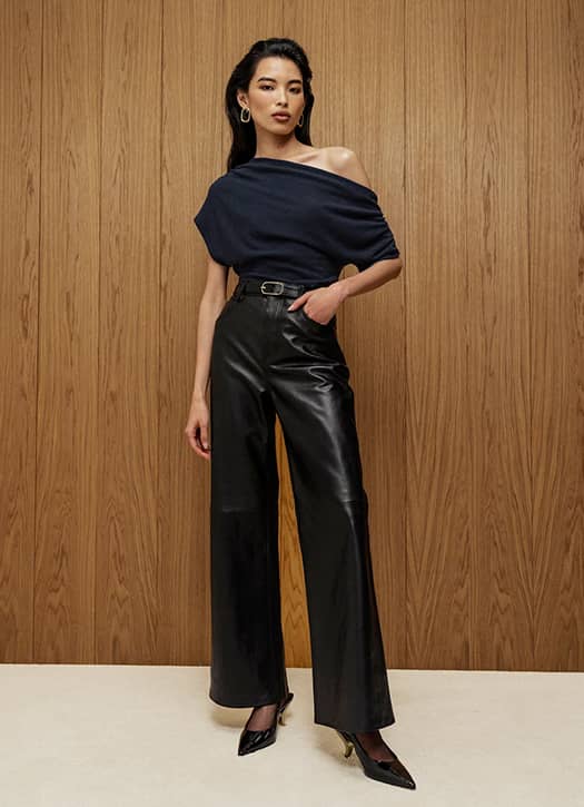 Woman wearing a knit top with tailored trousers for a Parisian date night outfit