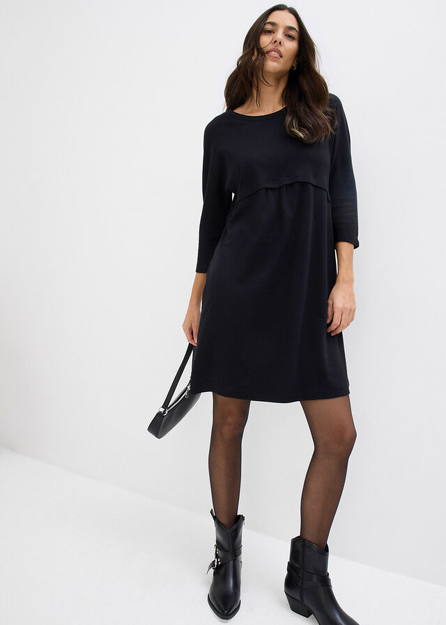 Woman wearing tights with a midi dress and ankle boots