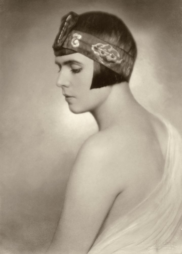 Vintage-style portrait of a sleek bob with an embroidered headband