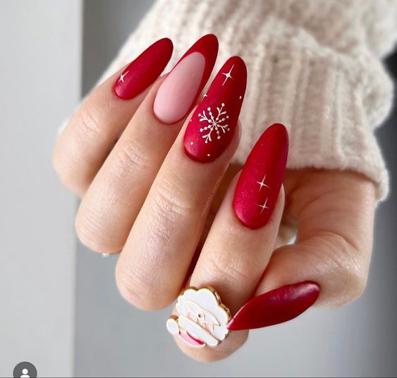 Matte classic red almond nails with white snowflakes and tiny stars