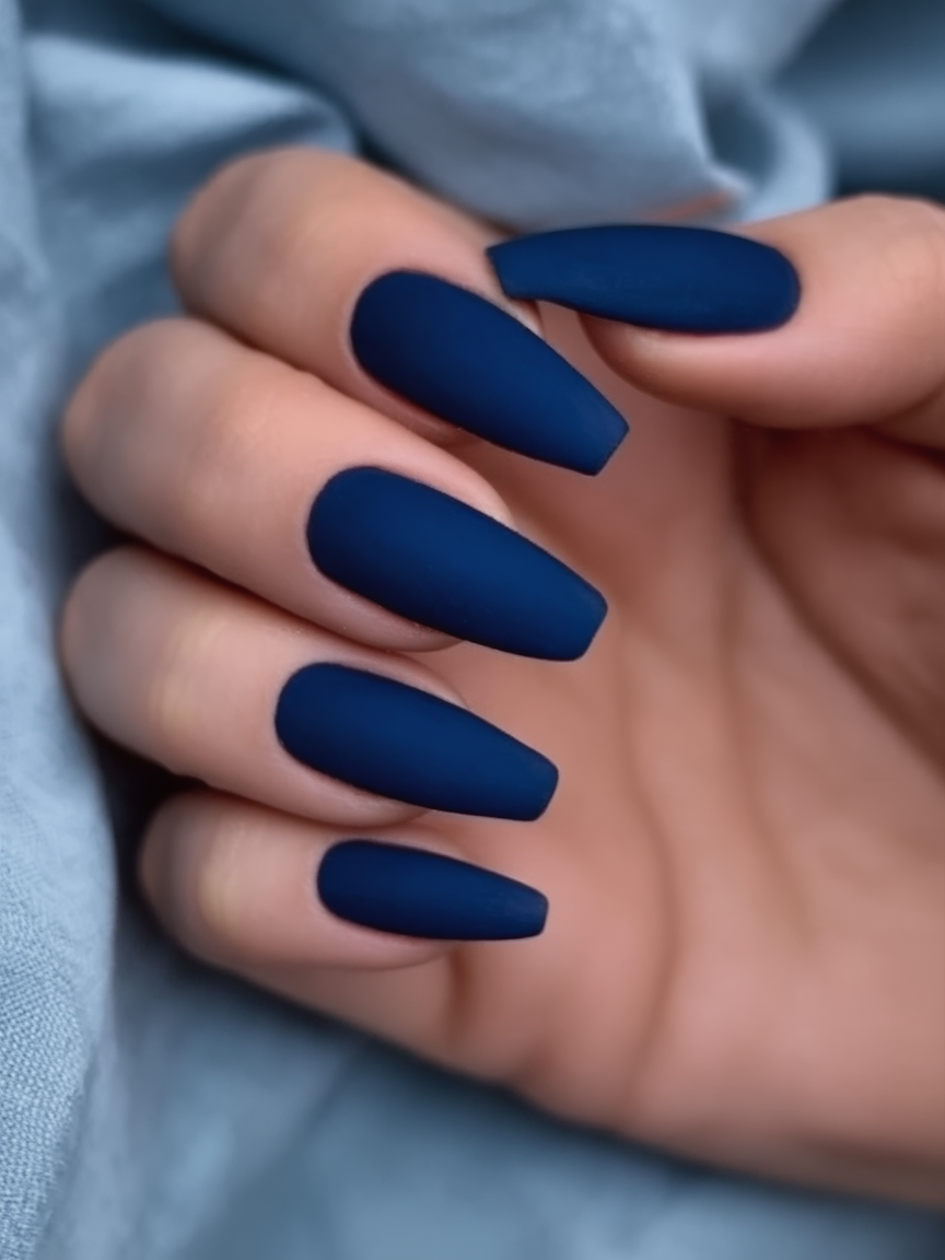 Long coffin nails in solid matte navy blue with a velvet finish
