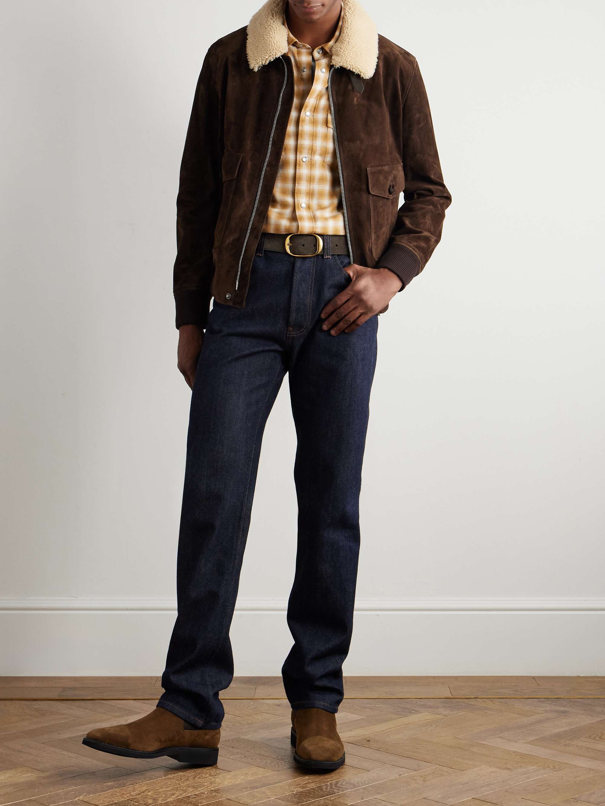 Shearling-collar brown suede jacket worn with a yellow plaid shirt, dark jeans and suede boots