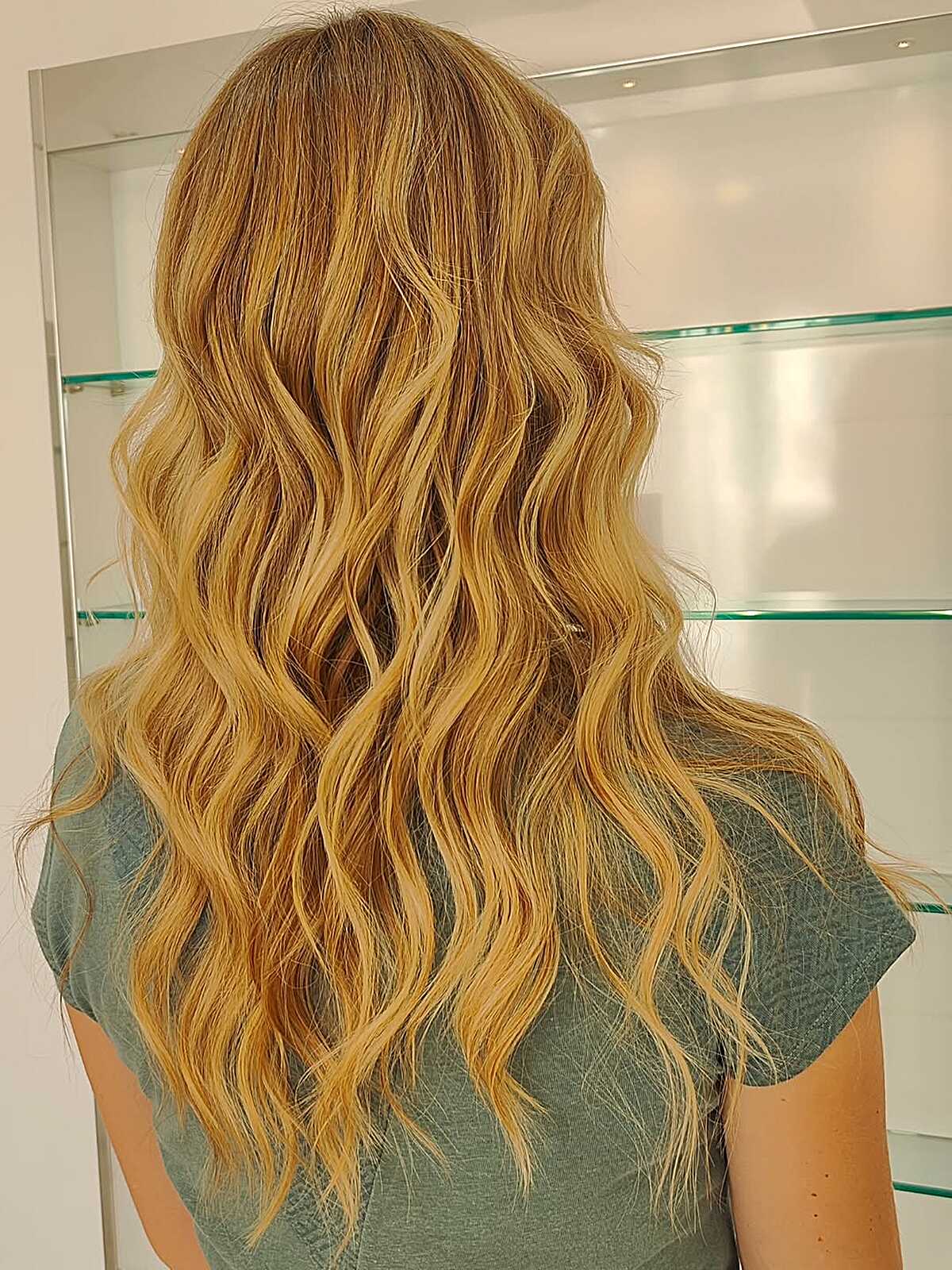 Loose textured waves with warm golden amber balayage