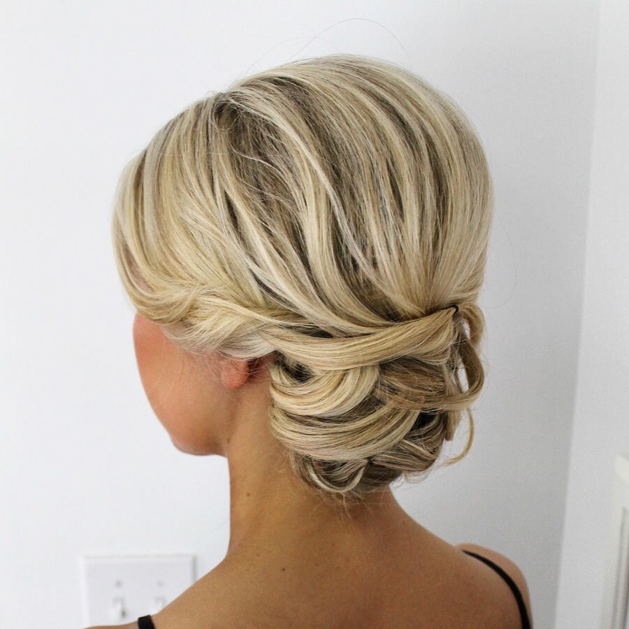 Blonde side-swept twisted bun from a bridal hair-and-makeup artist's portfolio.