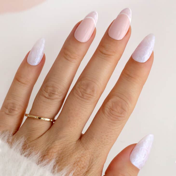 Pale pink almond nails with double-line white french tips and lace-textured accent nails