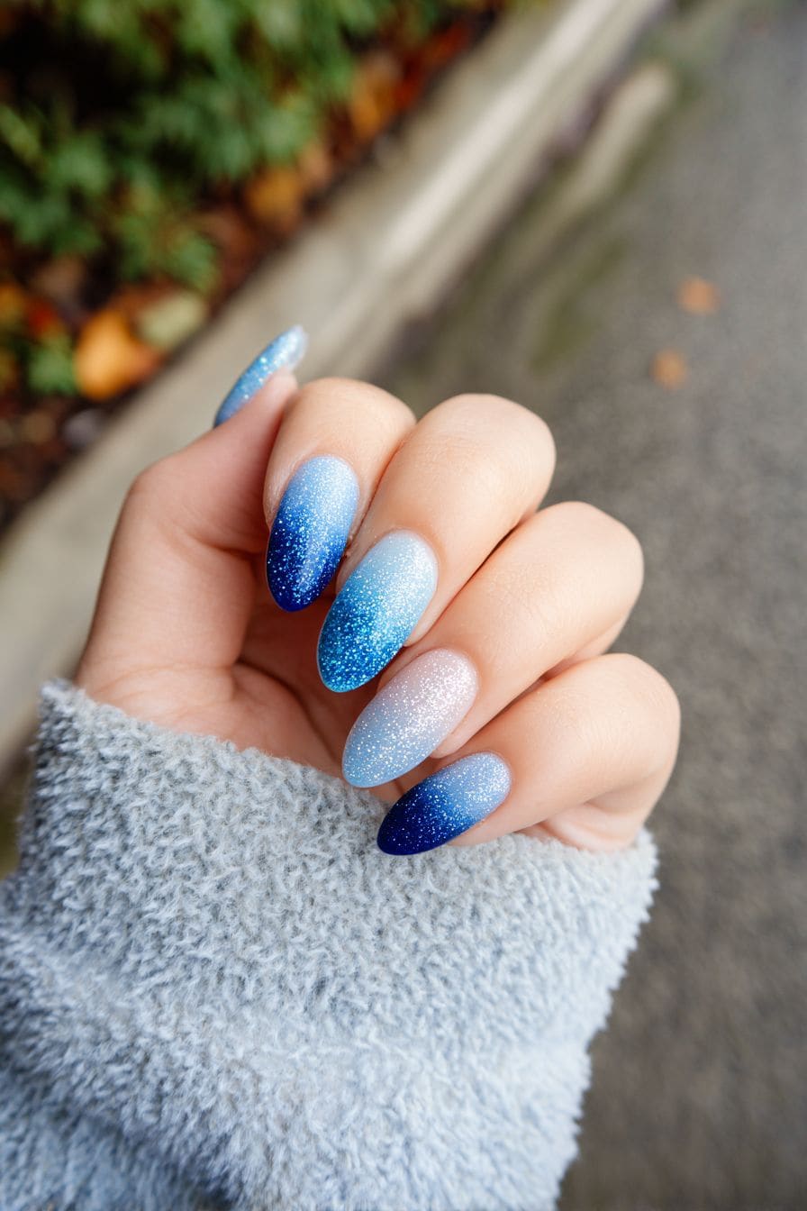 Short oval nails with icy blue glitter ombre fade