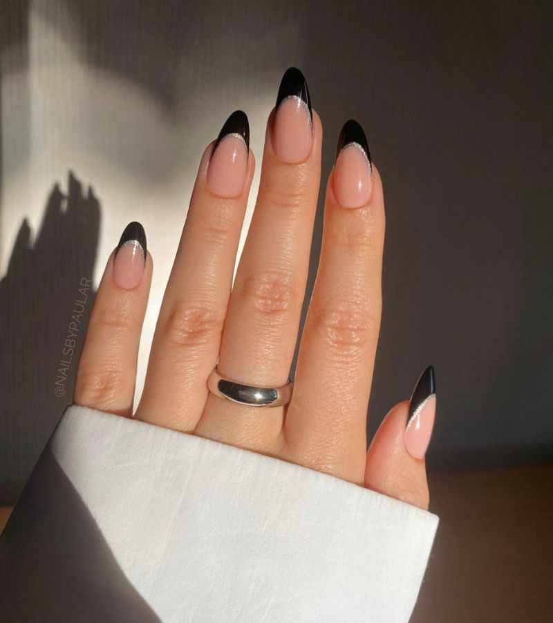 Nude nails with black French tips and a thin silver line