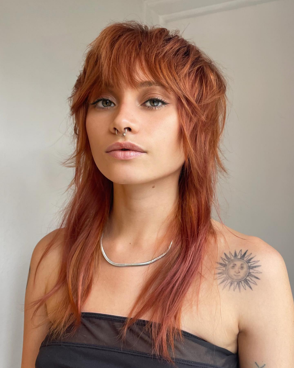 Grown-out wolf cut with shaggy layers and volume at the crown