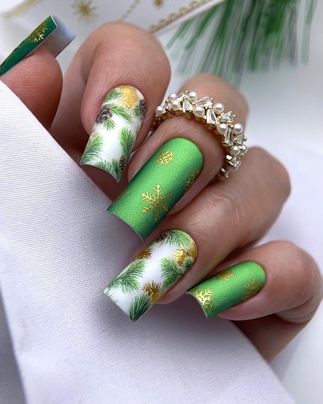 Matte emerald green nails with snowflake nail art